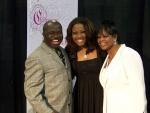 Charmaine Swimpson posing with Michael M Smith and wife Sharon Smith