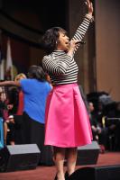 Erica Campbell lifts her hand in praise