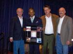 Donald Lawrence receives his award from Ken Pennell, Larry Blackwell, and Billboard's representative