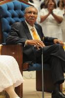 Rev Evans sits in his chair